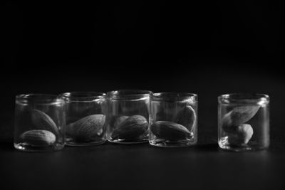 Close-up of glasses on table against black background