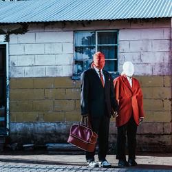 Rear view of man standing against wall