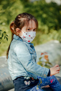 Portrait of cute girl standing outdoors