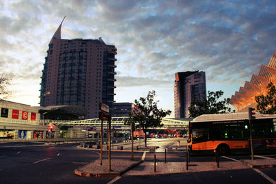 Buildings in city against cloudy sky