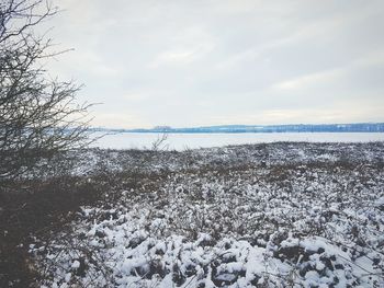 Scenic view of frozen lake against sky during winter