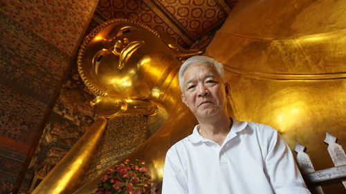 Low angle view of statue against temple