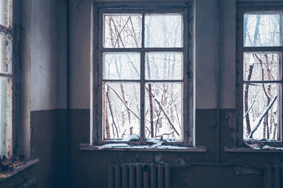 Broken glass window of abandoned house