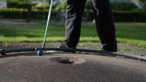 Low section of man playing golf