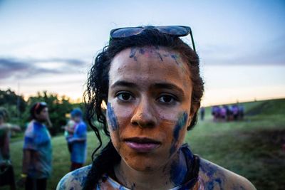 Close-up portrait of woman covered in powder paint