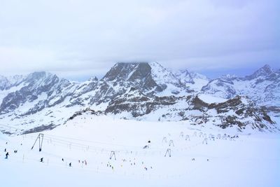 Scenic view of snow covered mountains against sky