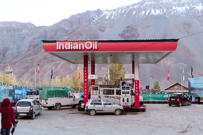 Cars on road against snowcapped mountains