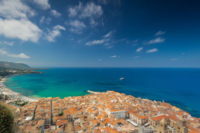 High angle view of townscape by sea against sky