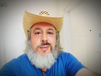 Portrait of man wearing hat at home