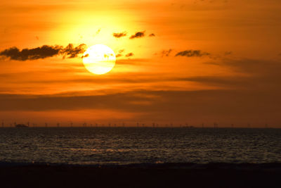 Scenic view of sea against orange sky