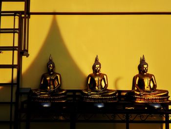 Close-up of buddha statues against building