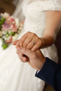 Midsection of couple holding hands