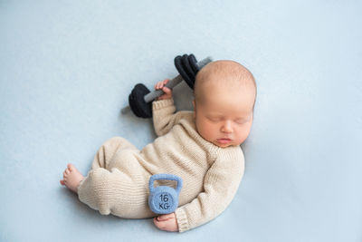 High angle view of cute baby boy lying on table