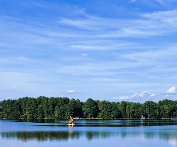 Scenic view of swimming pool by lake against sky