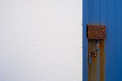 Close-up of white door on wall