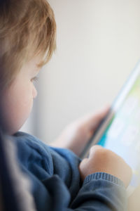 Close-up of boy using digital tablet