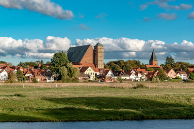 Houses on field against sky