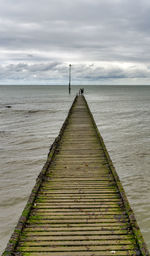 Pier over sea against sky