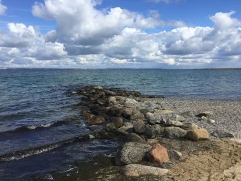 Scenic view of sea against cloudy sky