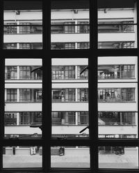 Buildings in city seen through glass window