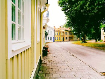 Footpath amidst buildings in city