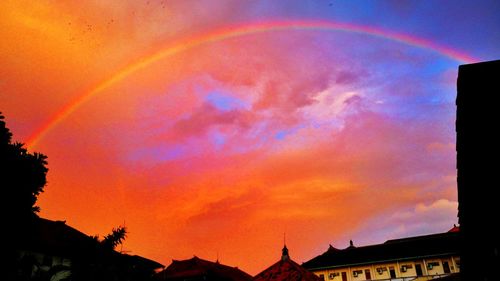 Low angle view of rainbow in sky at sunset