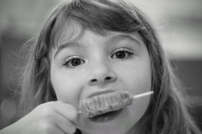 Close-up portrait of girl eating ice cream