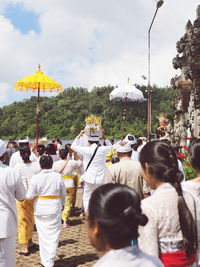 People on cross against sky