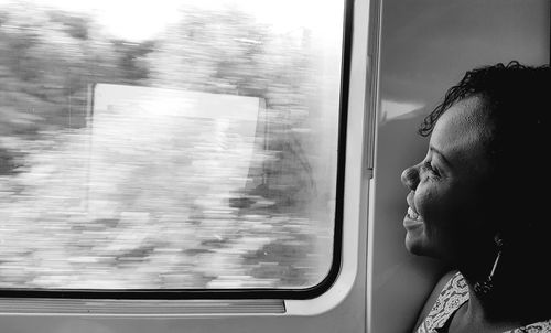 Smiling woman looking through train window