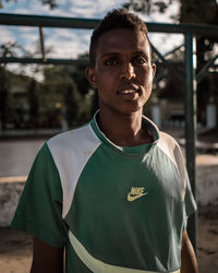 Portrait of young man standing outdoors