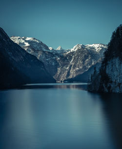 Scenic view of lake and snowcapped mountains against sky