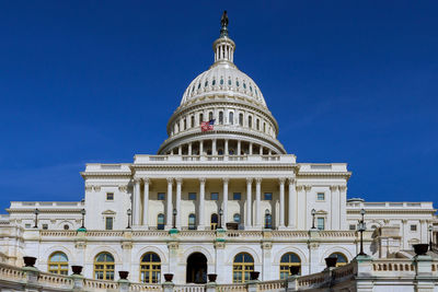 Low angle view of historic building against blue sky