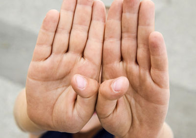 Close-up of hands stop gesture