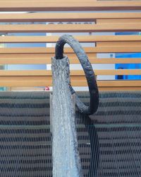 Close-up of wet metal railing against wall