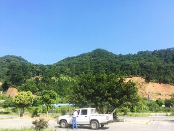 Cars on road against clear sky