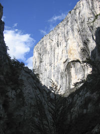 Low angle view of rock formation against sky