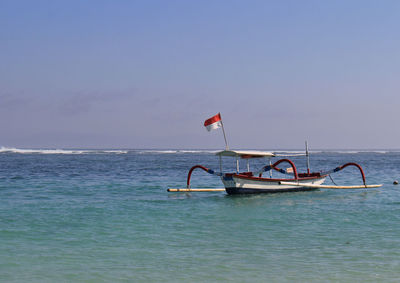 Sailboat in sea against sky