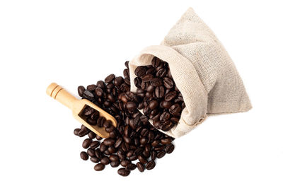 High angle view of coffee beans against white background
