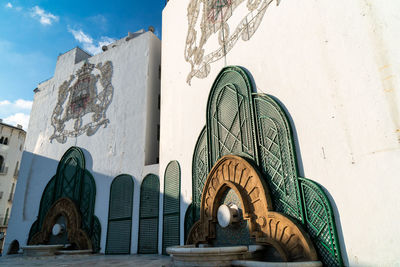 Low angle view of painting on building against sky