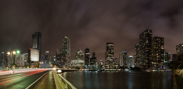 Illuminated cityscape against sky at night