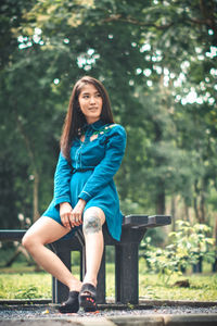 Portrait of smiling young woman sitting on seat