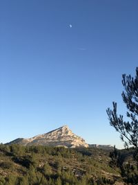 Scenic view of mountains against clear blue sky