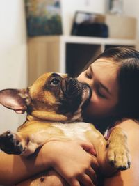 Portrait of woman with dog at home