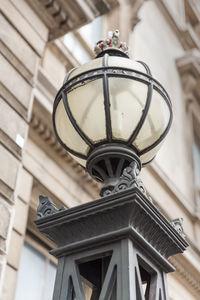 Low angle view of street light against building