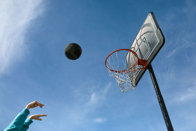 Basketball in air against blue sky