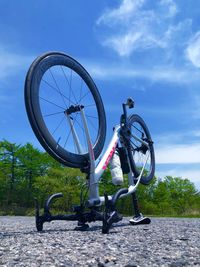 Low angle view of bicycle wheel against sky