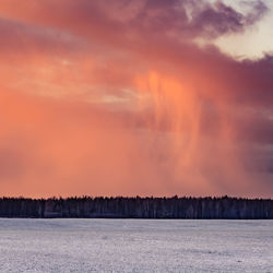 A beautiful, bright, colorful landscape of a winter sunrise. bright sky and first snow. 