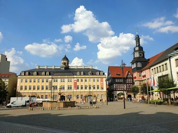 Eisenach city center town square with fountain under blue sky white clouds...