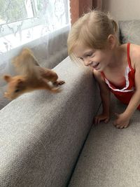 High angle view of girl with dog at home
