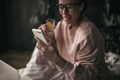 Young woman using mobile phone outdoors